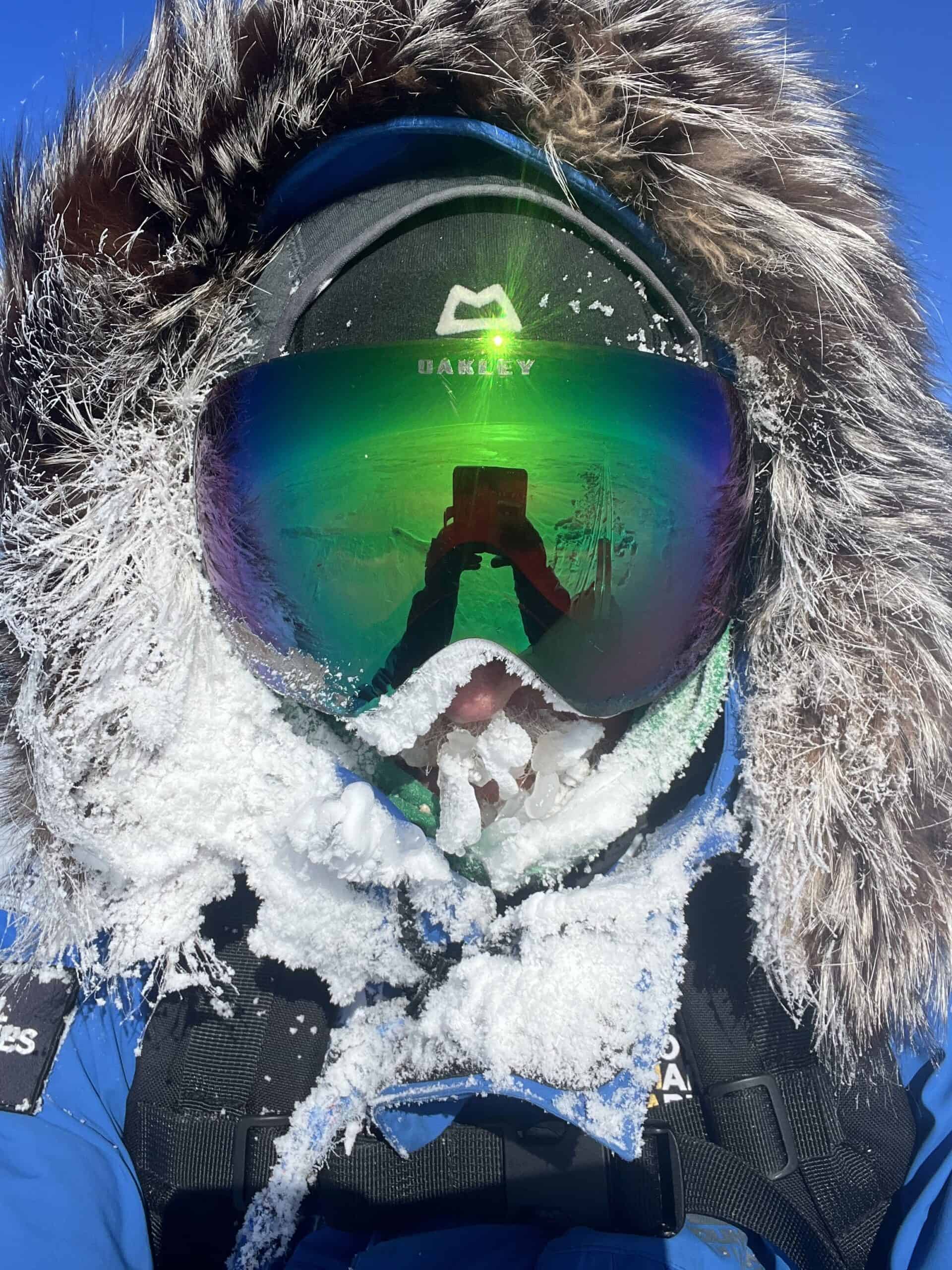 A Mission Spiritus team member with ice and snow covering the visible parts of their face and beard, taken in Antarctica