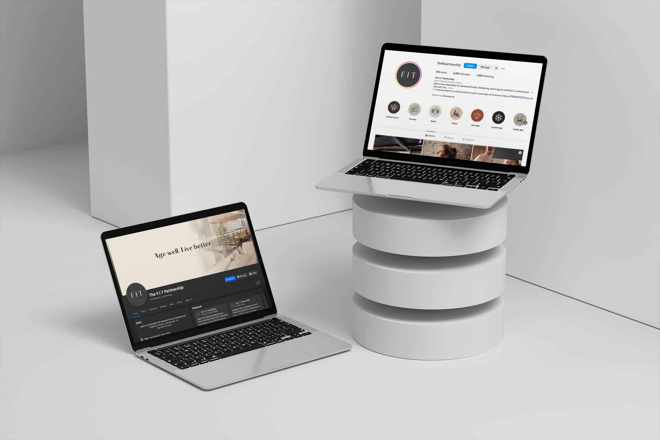 Two laptops, each displaying a different one of The FIT Partnership's social media platforms